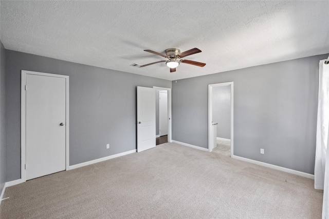 unfurnished bedroom with carpet floors, baseboards, ceiling fan, and visible vents