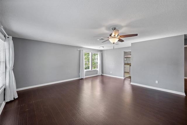 unfurnished room featuring a textured ceiling, baseboards, wood finished floors, and ceiling fan
