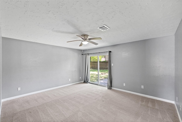 unfurnished room with visible vents, ceiling fan, carpet flooring, and baseboards