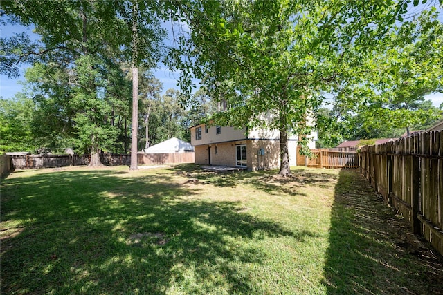 view of yard with a fenced backyard