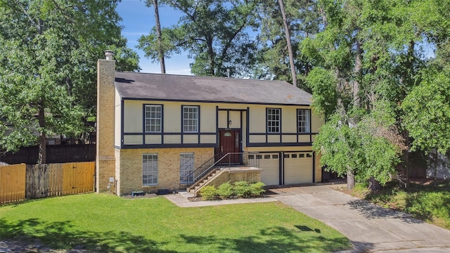raised ranch with an attached garage, a chimney, fence, stucco siding, and a front lawn