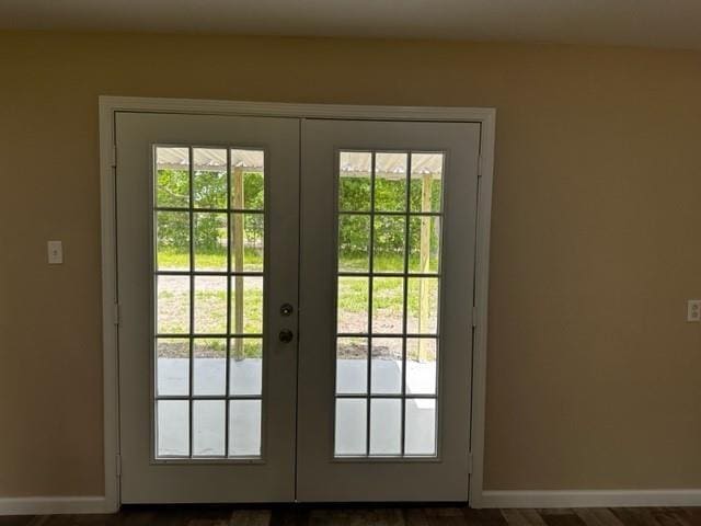 entryway featuring baseboards, a healthy amount of sunlight, and french doors