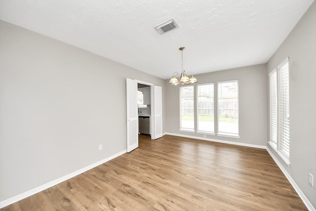 619 Shenandoah Dr, Shenandoah, TX 77381 - unfurnished dining area featuring light wood-type flooring, visible vents, a notable chandelier, and baseboards
