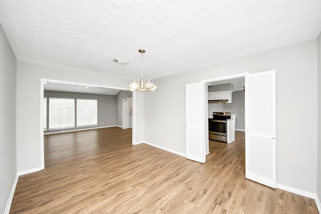 619 Shenandoah Dr, Shenandoah, TX 77381 - unfurnished dining area with a chandelier, light wood-style floors, baseboards, and visible vents