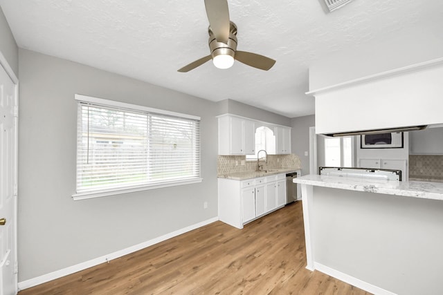 619 Shenandoah Dr, Shenandoah, TX 77381 - kitchen featuring tasteful backsplash, ceiling fan, a sink, and white cabinets