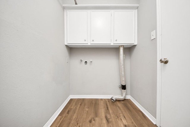 619 Shenandoah Dr, Shenandoah, TX 77381 - laundry area with wood finished floors, washer hookup, baseboards, and cabinet space