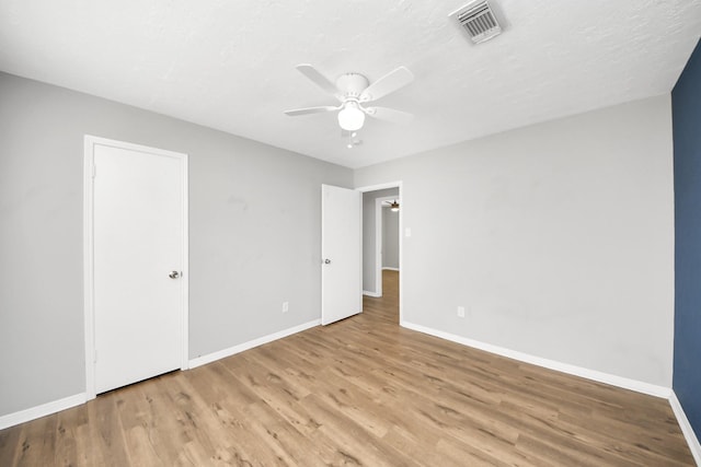 619 Shenandoah Dr, Shenandoah, TX 77381 - unfurnished bedroom with visible vents, baseboards, ceiling fan, and wood finished floors