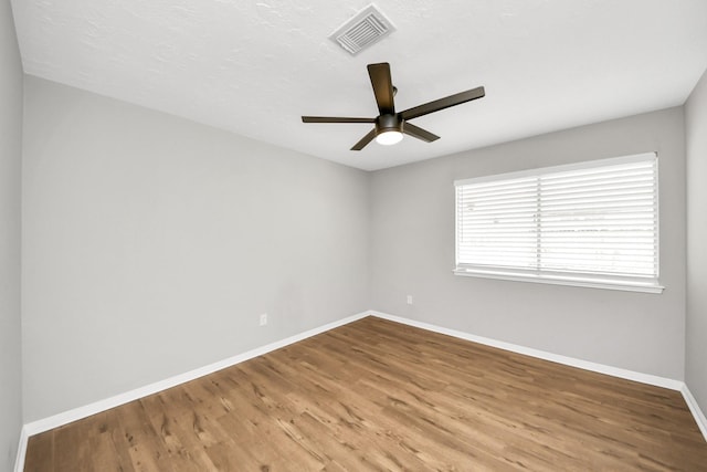 619 Shenandoah Dr, Shenandoah, TX 77381 - spare room featuring visible vents, baseboards, ceiling fan, and wood finished floors