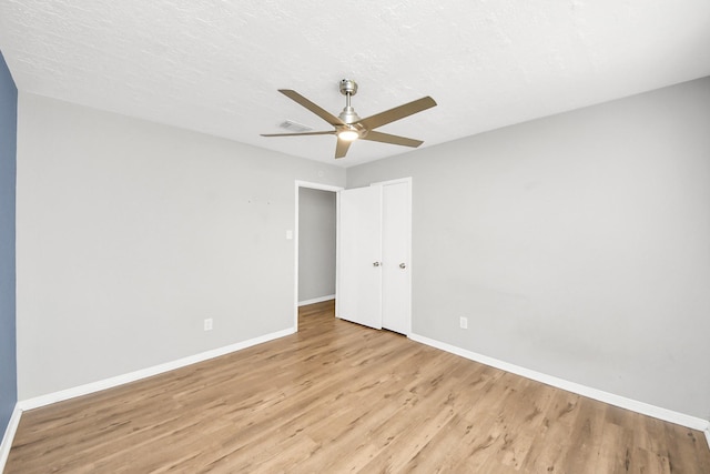 619 Shenandoah Dr, Shenandoah, TX 77381 - unfurnished bedroom with light wood-style floors, baseboards, visible vents, and ceiling fan
