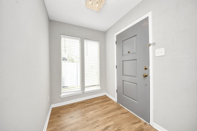 619 Shenandoah Dr, Shenandoah, TX 77381 - doorway to outside with baseboards and light wood finished floors