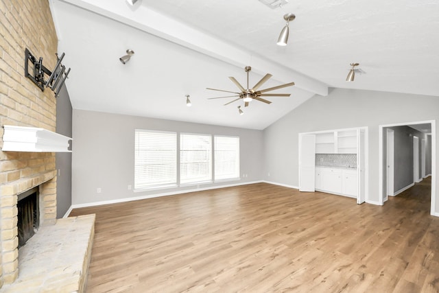 619 Shenandoah Dr, Shenandoah, TX 77381 - unfurnished living room with light wood-style floors, a fireplace, vaulted ceiling with beams, and baseboards