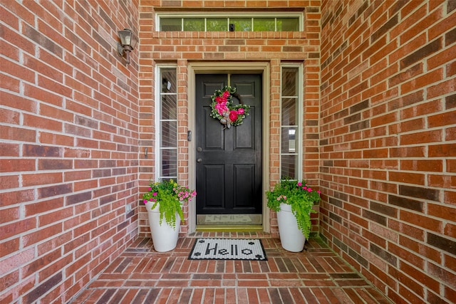 doorway to property with brick siding