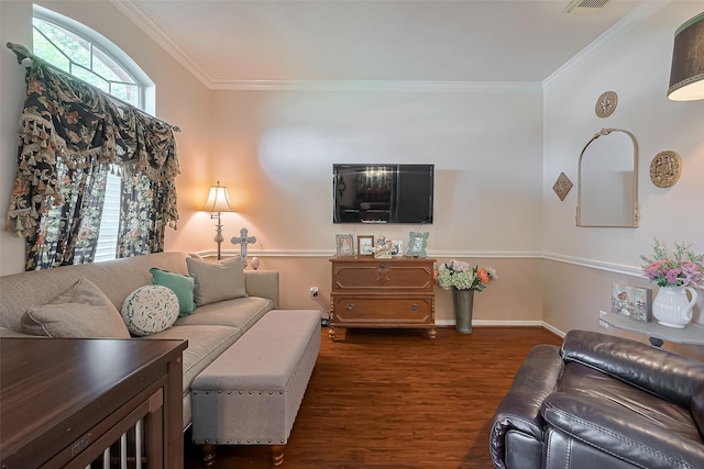 living area with crown molding, visible vents, baseboards, and wood finished floors