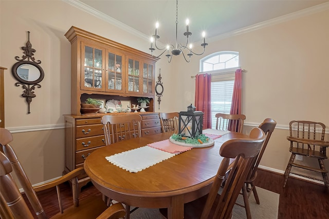 dining room featuring baseboards, an inviting chandelier, ornamental molding, and wood finished floors