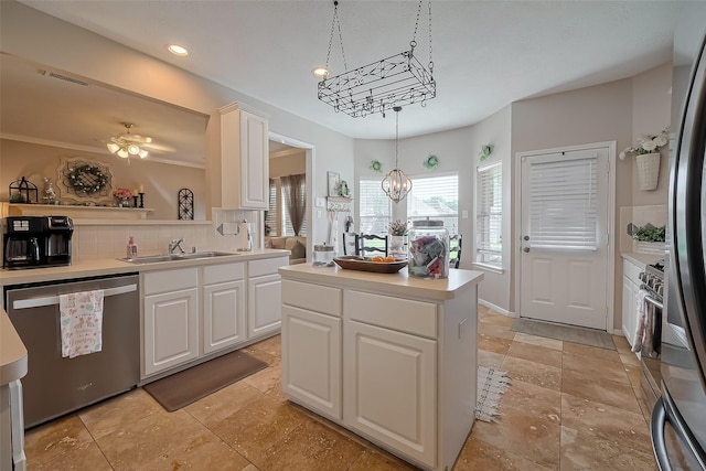 kitchen featuring visible vents, a sink, appliances with stainless steel finishes, a chandelier, and decorative backsplash