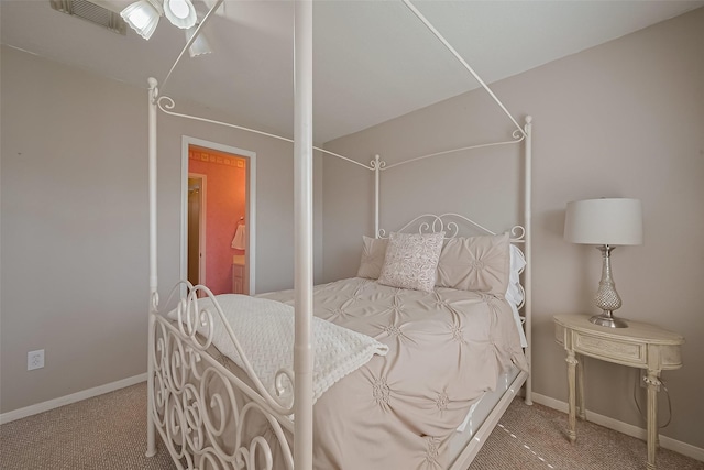carpeted bedroom featuring visible vents and baseboards