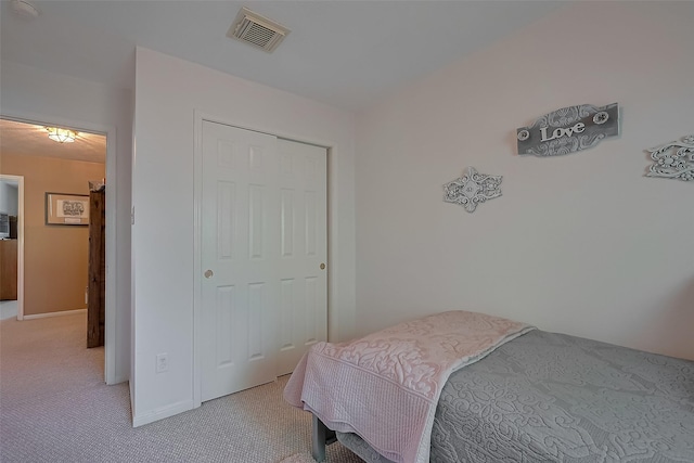 bedroom with light colored carpet and visible vents