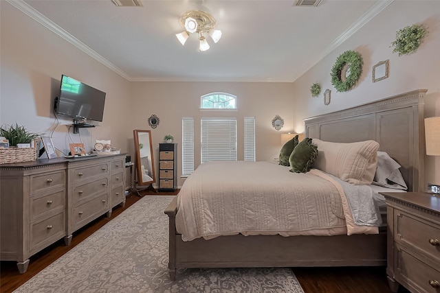bedroom with dark wood-type flooring, crown molding, and visible vents