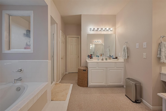 bathroom with a bath, a stall shower, vanity, and baseboards