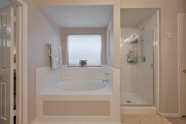 full bath featuring a bath, a stall shower, and baseboards