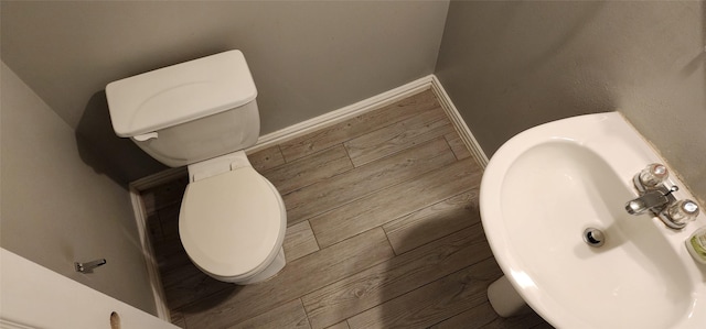 3327 Fiorella Way, Humble, TX 77338 - bathroom featuring toilet, baseboards, a sink, and wood finished floors