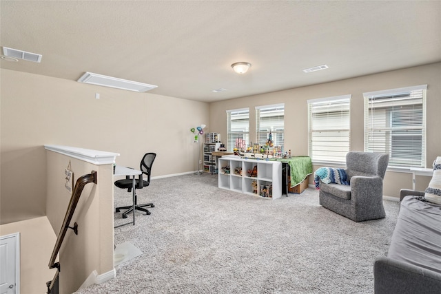 carpeted office space with visible vents and baseboards