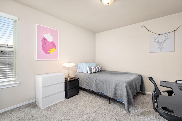 carpeted bedroom featuring baseboards
