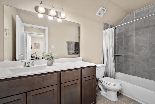 full bathroom with vanity, visible vents, toilet, lofted ceiling, and tile patterned floors