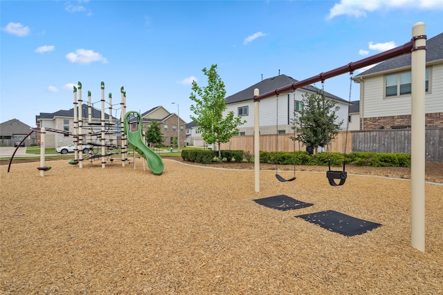 community playground featuring a residential view and fence