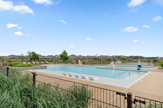 community pool featuring a residential view and fence