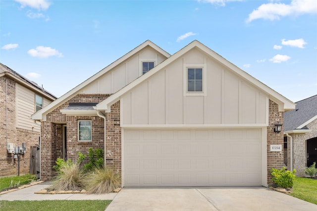 view of front of house featuring board and batten siding, brick siding, a garage, and driveway