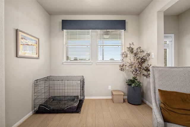 living area with wood finished floors and baseboards
