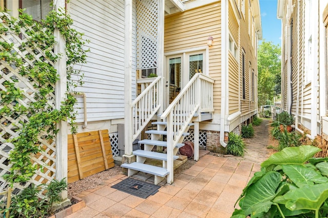 view of exterior entry with a patio area