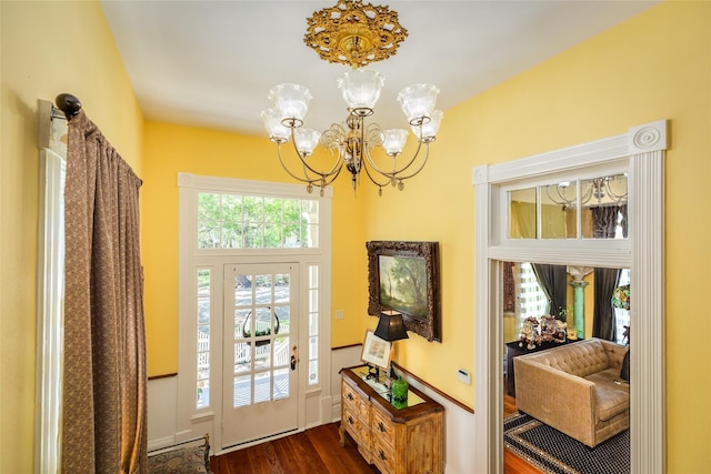 foyer featuring a chandelier and dark wood finished floors