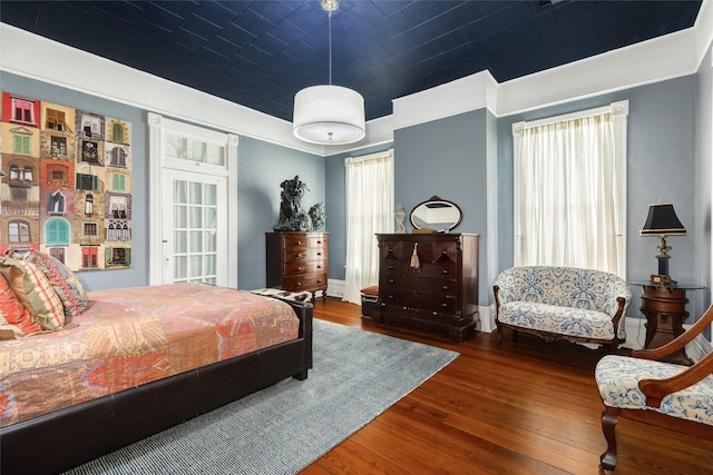 bedroom featuring wood finished floors and baseboards