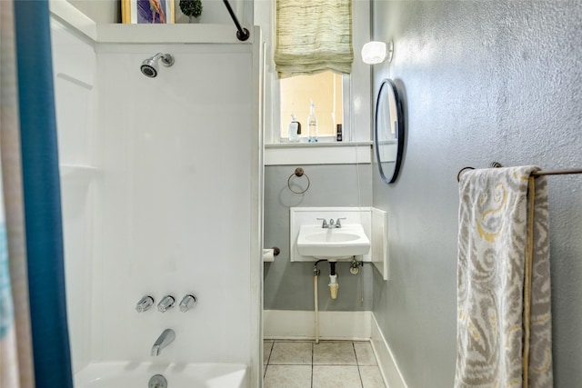full bathroom with a sink, tile patterned floors, bathing tub / shower combination, and baseboards