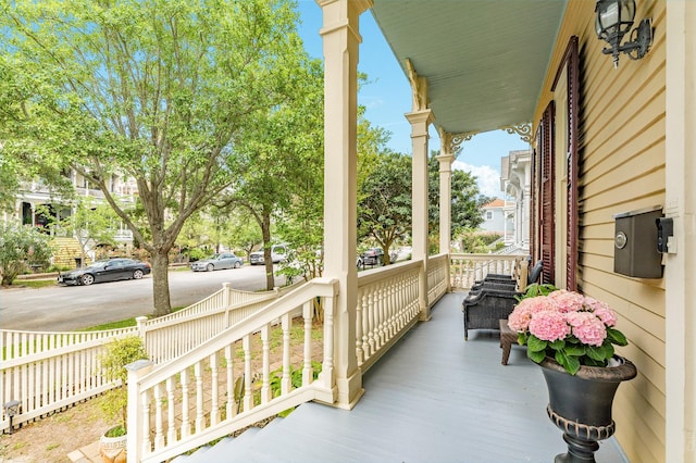 deck with a porch and fence