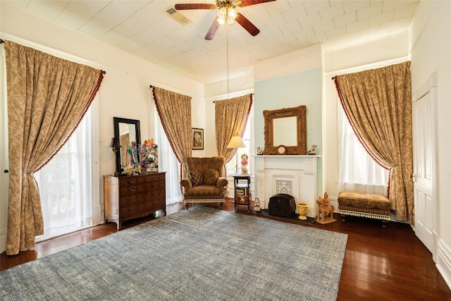 sitting room with a fireplace, hardwood / wood-style floors, and a ceiling fan