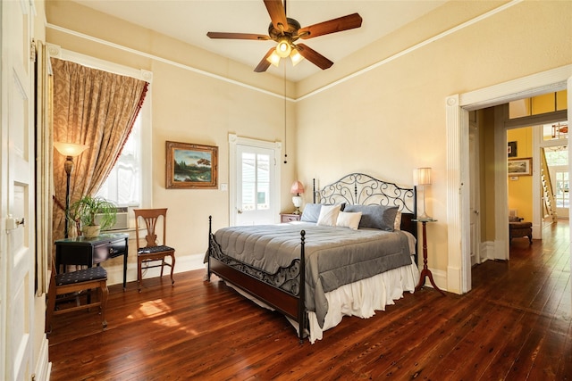 bedroom featuring cooling unit, dark wood-style floors, multiple windows, and baseboards