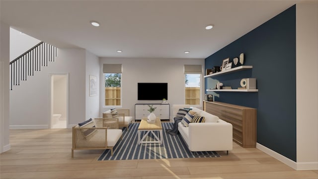 living area featuring stairway, baseboards, light wood-type flooring, and recessed lighting