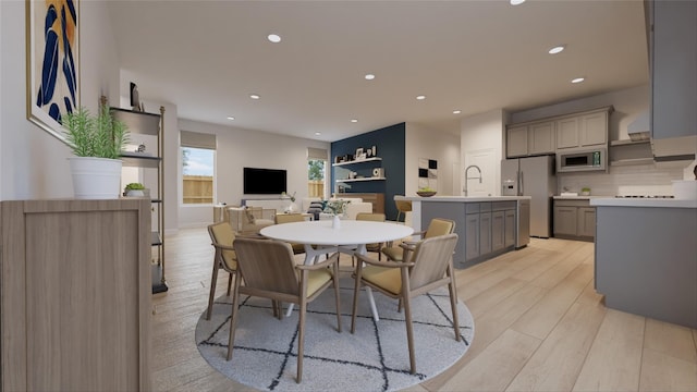 dining space with recessed lighting and light wood-style floors