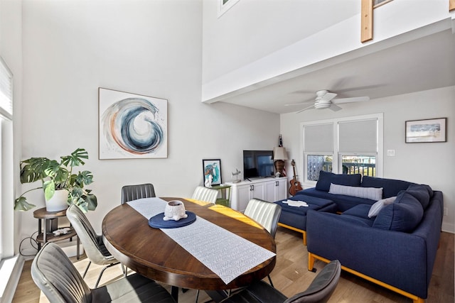 dining area featuring light wood finished floors and a ceiling fan