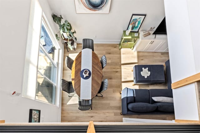 interior space with wood walls, baseboards, and wood finished floors