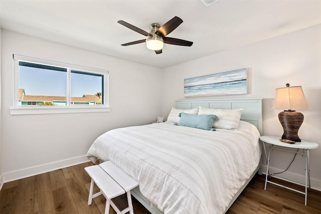bedroom featuring baseboards, a ceiling fan, and wood finished floors
