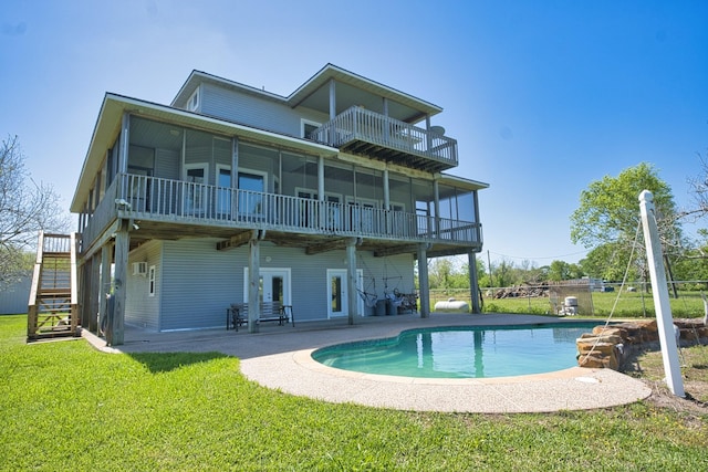 3054 Fm 2611th Rd, Brazoria, TX 77422 - back of house featuring a yard, a balcony, a patio area, stairway, and an outdoor pool