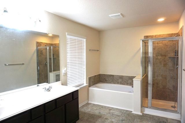 bathroom with a bath, a stall shower, and vanity