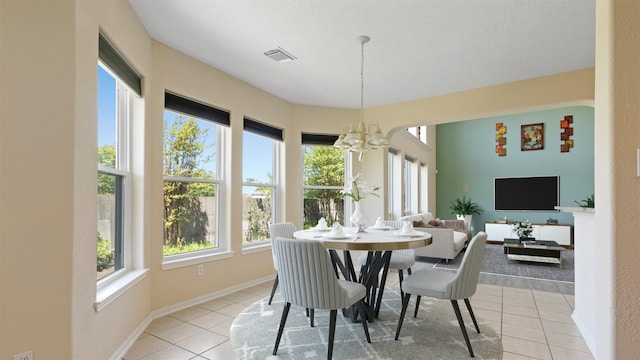 dining room with baseboards, visible vents, a chandelier, and light tile patterned floors