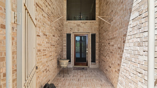 doorway to property with brick siding