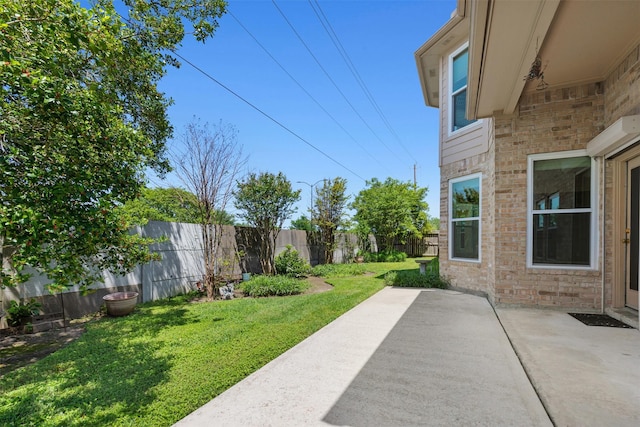 view of yard with a fenced backyard and a patio area