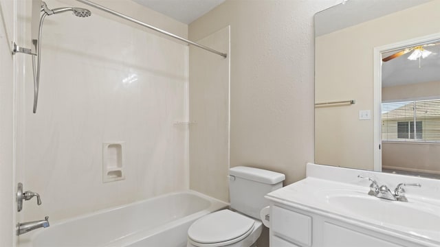 bathroom with a ceiling fan, shower / bath combination, vanity, and toilet